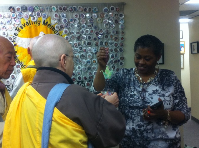 Sr. Clare Carter presents Tina Cherry host and founder of the Louis D. Brown Peace Institute with Peace Cranes